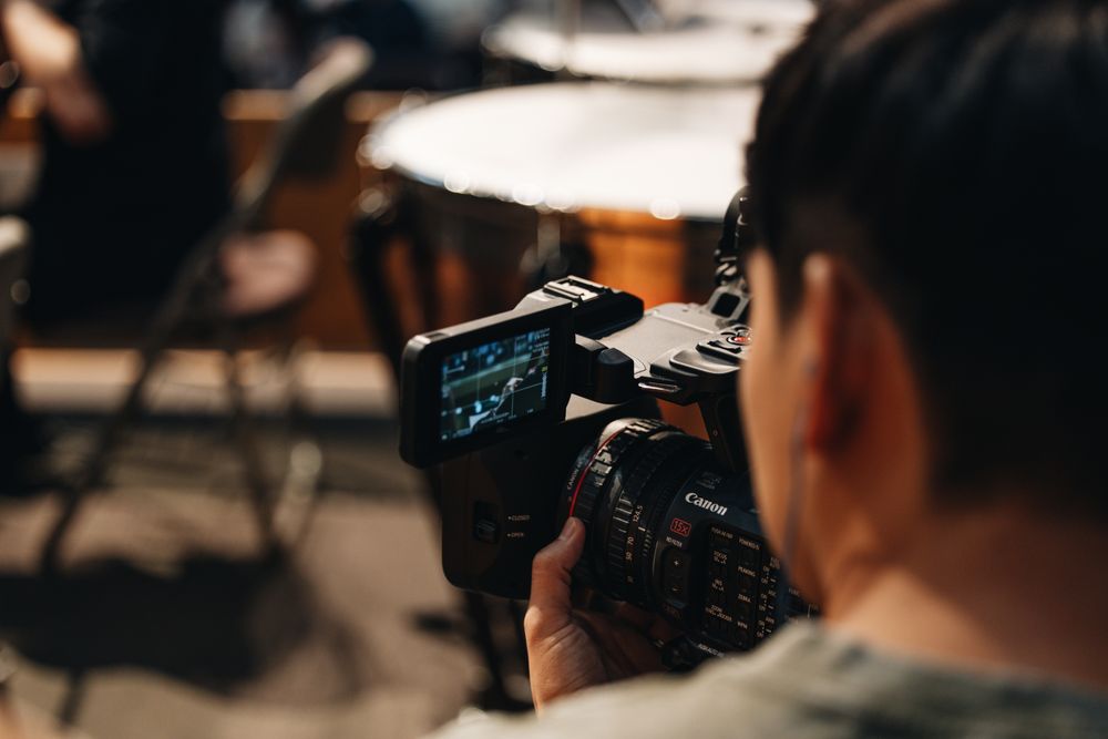 A camera operator recording a live music performance