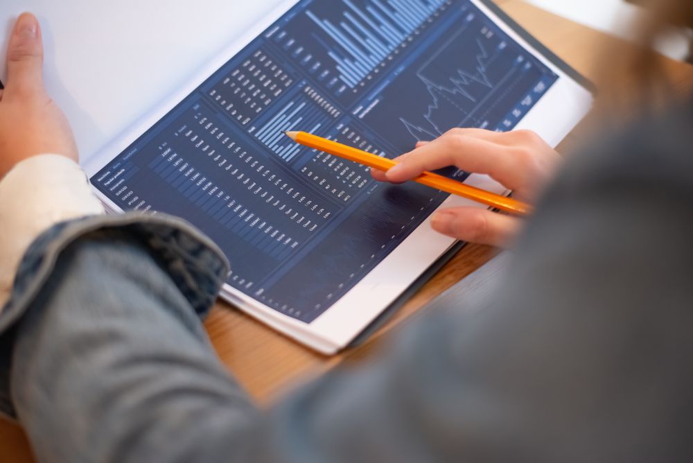 A person reviewing business data on a tablet